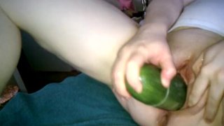 Cucumber spreading pink pussy.